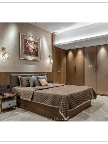 This bedroom design emphasizes seamless integration. Floor-to-ceiling wardrobes with a glossy finish provide ample storage while blending into the wall, and layered lighting creates a soft, relaxing ambiance.