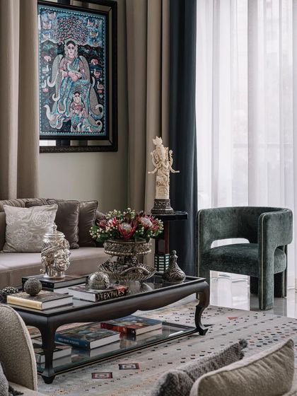 The living room is a curated collection of art and artifacts, including a traditional Pichwai painting, reflecting the designer's personal taste.