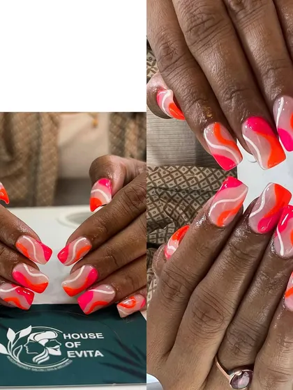 This is where your imagination comes to life. This set of custom nail art features a vibrant, abstract wave design in neon pink and orange. It shows my ability to work with bright colors and create unique, freehand patterns.