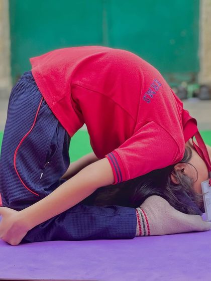 A reclining split pose, showing the flexibility that can be developed at a young age with proper guidance.