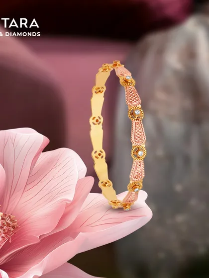 The warmth of rose gold meets the light of diamonds in this elegant bangle. The design alternates between textured rose gold and smooth yellow gold links, wrapping the wrist in a subtle shimmer.