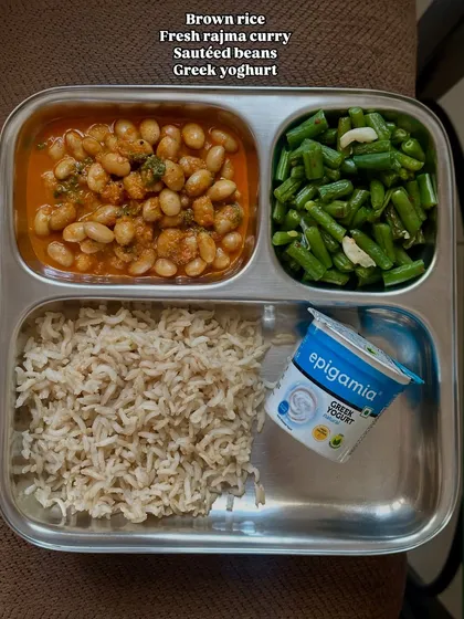 A plate showing brown rice with fresh rajma curry, sautéed beans, and Greek yogurt. This is a simple, comforting, and protein-rich meal.