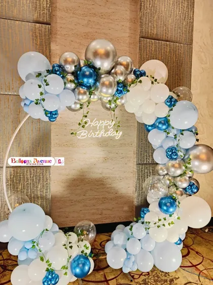 A different arrangement on a circular frame, using a cool palette of light blue, white, and metallic silver for a chic look.