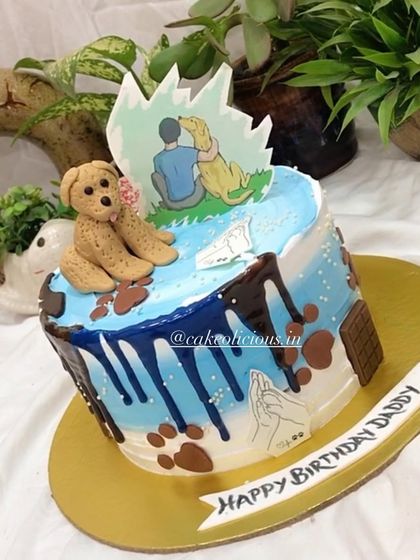 An angled view of the dog lover's birthday cake, showing the blue drip and paw print details.