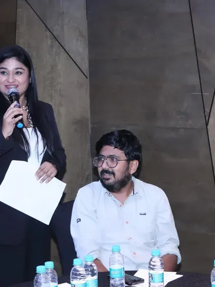 Sharing a light moment with a panelist at the NPCI event. Building rapport is key to a smooth show.
