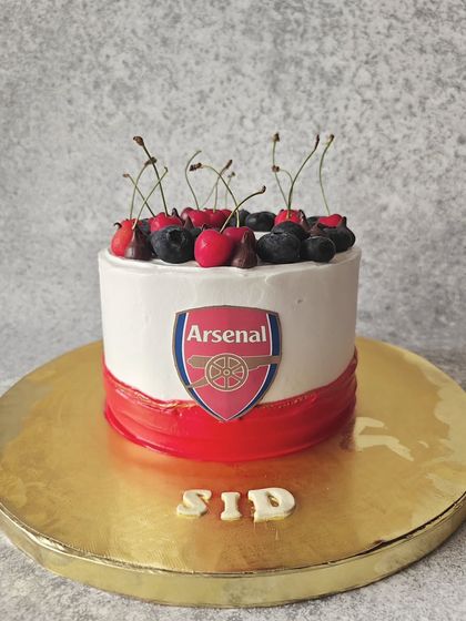 Here's one for the Arsenal fans. I created this Belgian chocolate cake with the team's logo and colors, and topped it with fresh cherries and blueberries for a burst of flavor.