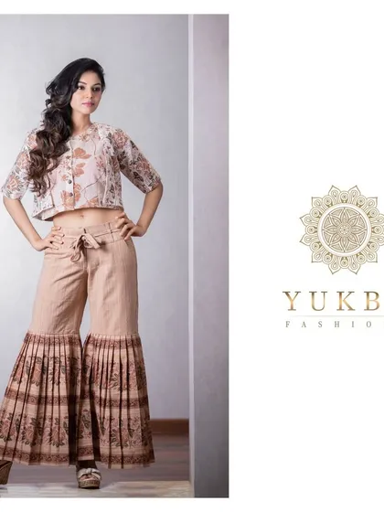 A model confidently posing in a contemporary crop top and palazzo set.