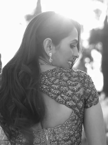 A beautiful black and white close-up, capturing an intimate moment in the custom Versace gown.