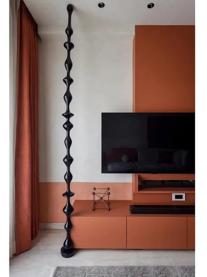 The full view of the TV wall, with its unique combination of textures, colors, and sculptural elements.