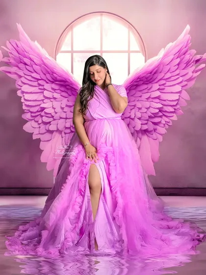 For a truly dreamy and unique photoshoot, we can use creative props like these beautiful angel wings. This is a popular choice in my Rohtak studio for creating an unforgettable, fairytale-like image.