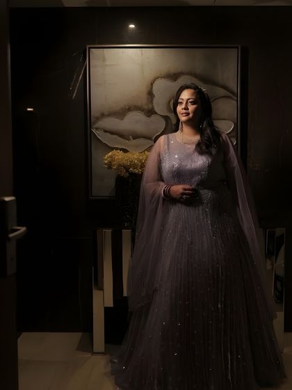 A dramatic, low-light shot that highlights the glamour of this reception look. The makeup is designed to catch the light beautifully, creating a radiant glow even in dim settings.