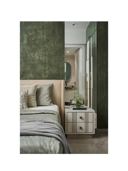 A detail shot of the young couple's bedroom, showing the textured olive green wall and the custom white bedside table.