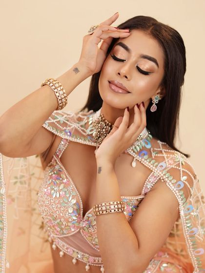 A serene, eyes-closed portrait that showcases the soft, shimmery eyeshadow and the glowing, contoured cheeks.