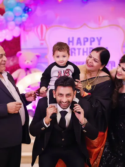 A wonderful multi-generational photo from a birthday celebration, filled with smiles.