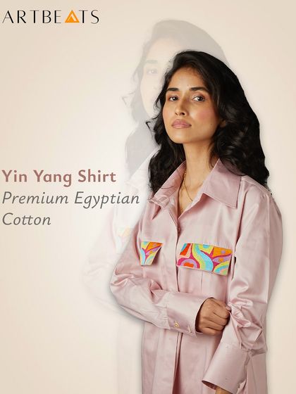 The Yin Yang Shirt in premium Egyptian cotton. This version comes in a beautiful pink, with two art-detailed pockets that add a playful and balanced touch to the luxurious fabric.