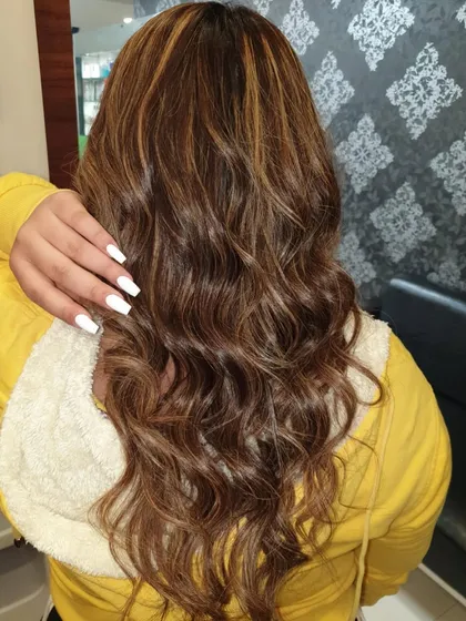 A great example of hair coloring and styling. This client wanted rich, natural-looking highlights with soft waves. You can see the dimension in the color and the healthy shine of the hair after the service.