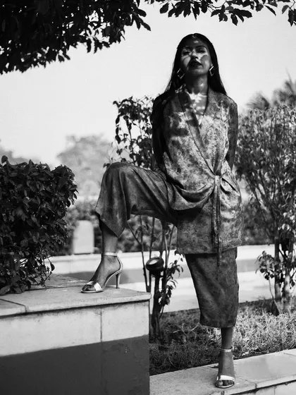 A high-contrast, black and white portrait of Anasuya Sengupta. The dramatic play of light and shadow creates a powerful, artistic image.