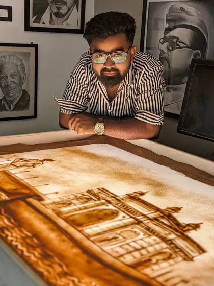 Posing with my finished sand art for the Lodha Group, depicting their founder and one of their iconic buildings.