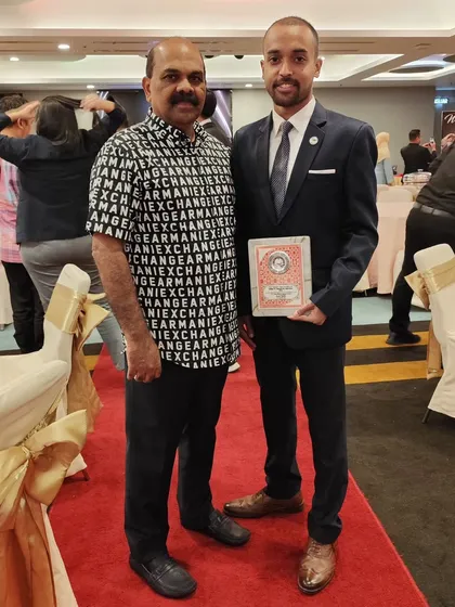 With my coach at the gala dinner. His guidance has been instrumental in my journey, both as an athlete and as a mentor.