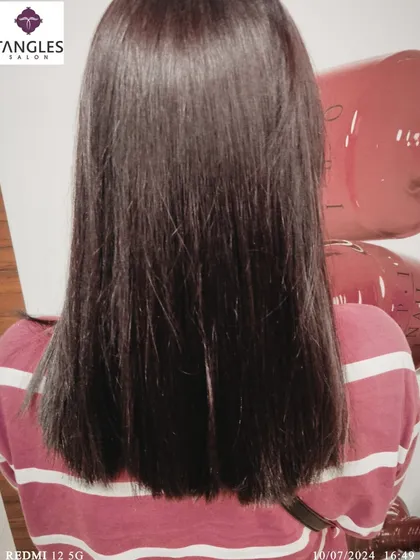 The final look of the global color service, showing smooth, straight hair with a healthy gloss. This is a perfect example of a classic, elegant hair color that is always in style.
