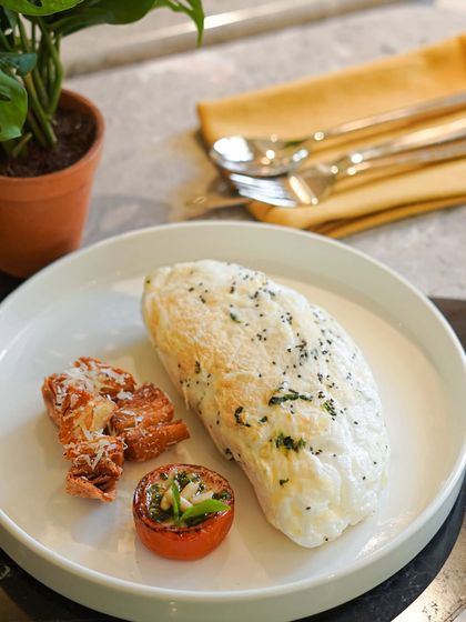 For a lighter but protein-packed option, try our Fluffy White Omelette. Made with organic egg whites, chia seeds, spinach, and parmesan, it's served with roasted tomatoes and potatoes.