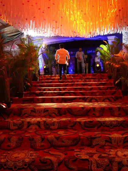 For the prestigious Zee Kannada 'Hemmeya Kannadiga' awards, we created a grand celebrity entrance with a patterned red carpet, dramatic lighting, and elegant floral arrangements, ensuring a VIP experience.