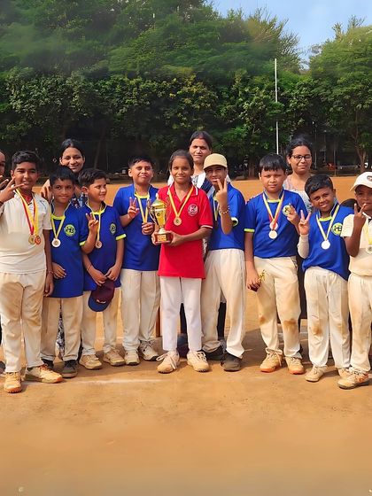 Victory signs and smiles from a young team with their trophy and medals. These are the moments that build a lifelong love for the sport.
