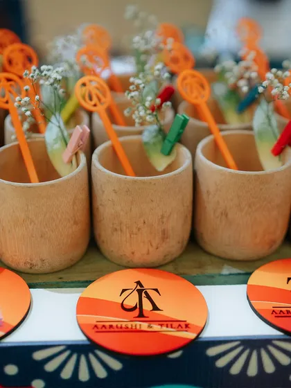 We provide unique and eco-friendly touches like these custom-branded coasters and bamboo-style cups. The small details are personalized with the couple's logo, creating a cohesive event identity.