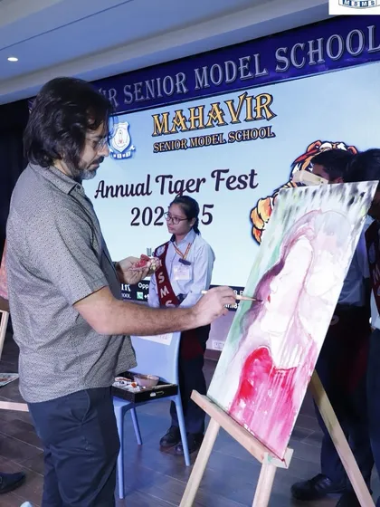 Here I am in my element, creating a painting live during the Annual Tiger Fest at a school. I love the energy of painting in front of a crowd, starting with a blank canvas and creating a finished piece that captures the spirit of the event. This is the core of my live art service.