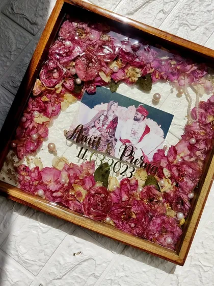 This teakwood shadow box frame is one of my most popular wedding keepsakes. Here, I've preserved a couple's varmala flowers and photo, creating a beautiful piece of home decor that tells their love story.