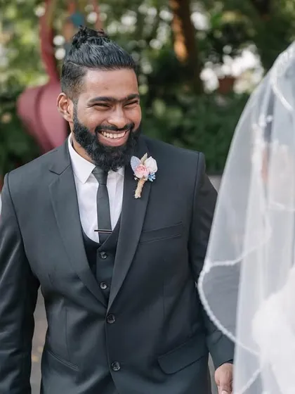 The groom's face lights up with a huge smile as he sees his bride in her wedding dress for the first time. This is the pure, unfiltered reaction I aim to capture.