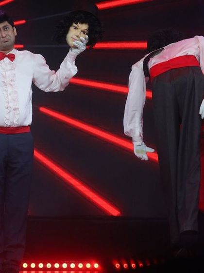 A different angle of the illusion act, showcasing the custom-built puppet body. Live stage shows allow for creative and interactive performances like this.