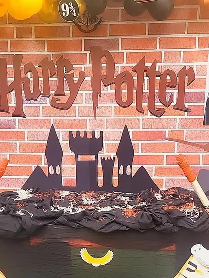A close-up of the Harry Potter backdrop, featuring the iconic font and a silhouette of the Hogwarts castle.