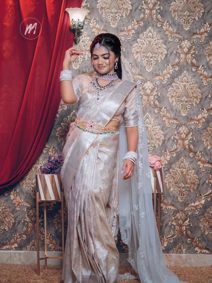 A graceful shot of the model in the silver saree, showing the beautiful flow of the fabric.