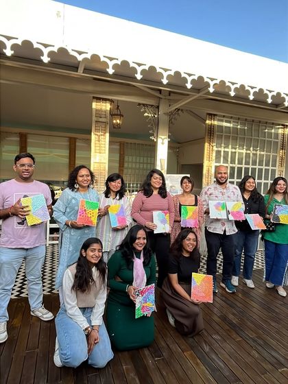 A happy group holding their colorful pastel-themed texture art. I love seeing a room full of proud new artists.