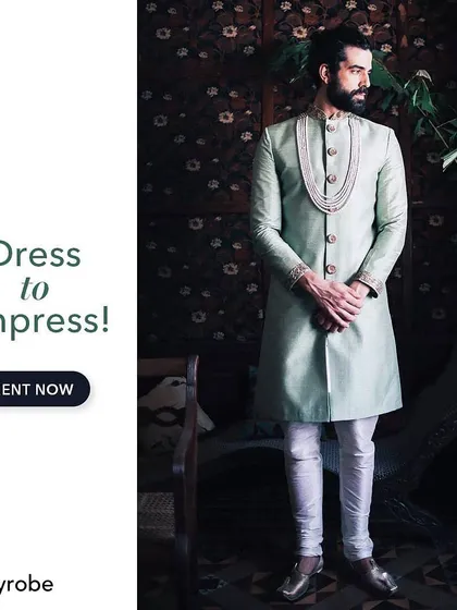Dress to impress with this elegant mint green sherwani. The subtle embroidery and attached pearl mala create a look of effortless royalty, perfect for a modern groom.