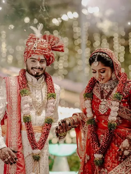 The couple makes their entrance at the wedding ceremony, surrounded by sparklers and purple smoke for a truly magical and colorful start to their new life together.