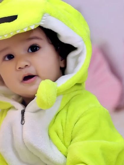 A close-up of the adorable dinosaur costume we provide for the shoot. The soft, comfortable outfit allows the baby to move freely while perfectly fitting the theme.
