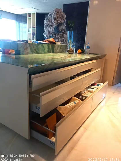 Deep, handleless drawers in this island counter provide ample storage for pots, pans, and other large items. I use high-quality tandem channels to ensure they glide smoothly and close silently, even when fully loaded.