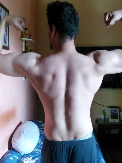 No filters, just the results of hard work. This is a normal, relaxed back pose showing the muscle definition that comes from consistent training and a clean diet.