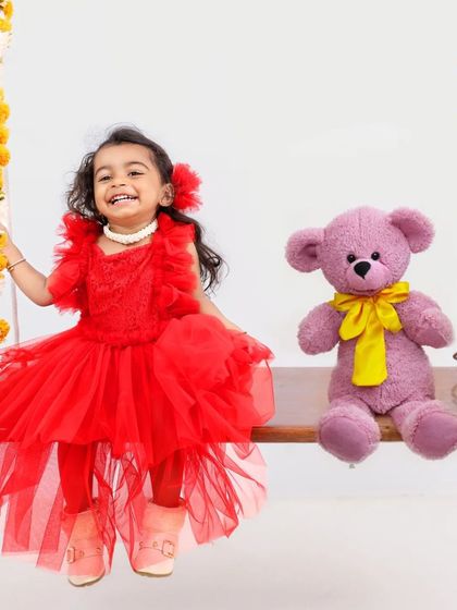 A close-up of the girl on the swing, her joyful laugh captured perfectly. This candid moment showcases the pure happiness of childhood.