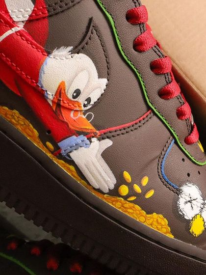 A close-up of Scrooge McDuck diving into his gold coins. I used vibrant colors and careful shading to make the characters pop on the brown leather of the Supreme AF1s.