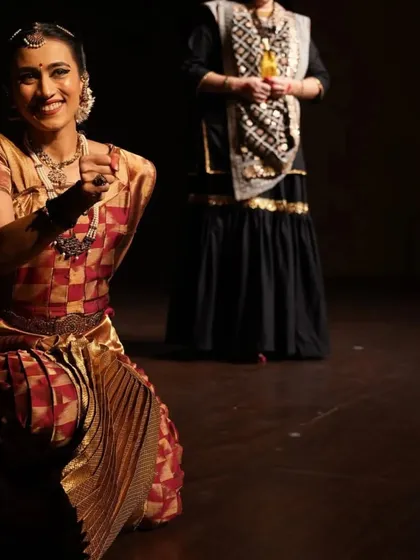 A kneeling pose from a performance, engaging directly with the audience. This image shows my ability to connect with viewers and draw them into the story being told on stage.