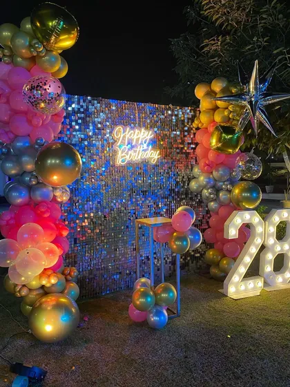 Another angle of the glamorous 28th birthday setup, highlighting the starburst foil balloons and sequin backdrop.