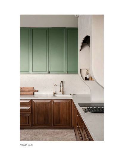 A close-up of the dry kitchen from 'Tinted Tapestries' featured in Architectural Digest, showing the mix of green and wood cabinetry.