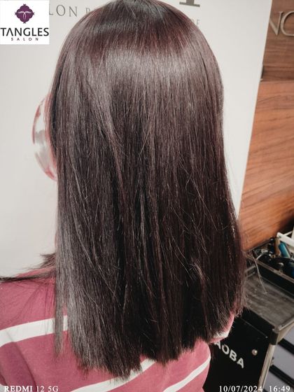 A back view of the deep mahogany global color, showing the evenness and shine of the application. A single, well-executed color can make the hair look incredibly healthy and polished.