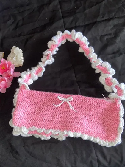 A clear shot of the pink and white ruffle bag on its own. The strap has this cute scrunchie-like ruffle effect that I create by hand.