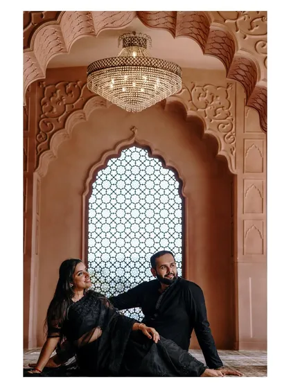 A regal pose from the couple's pre-wedding shoot. The makeup is designed to look flawless in professional photography.