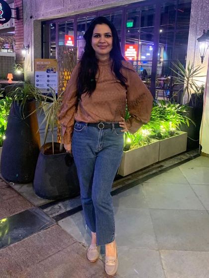 A simple yet stylish look for an evening out. I've paired a brown top with statement puff sleeves with a pair of classic blue jeans and loafers.