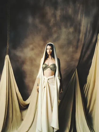 This wide shot captures the full dramatic effect of the styling and the complementary, understated makeup.